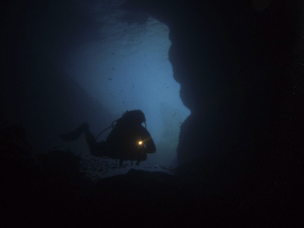 diving through cave at gato island.jpg